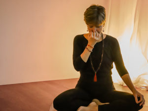 Woman doing pranayama with closed eyes